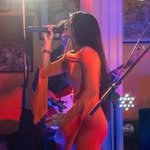 Wahida Hussain singing into a microphone